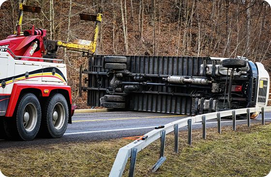 A heavy duty tow truck on the screne of a truck on rollover