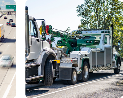 A heavy duty rotator towing a commercial truck