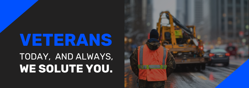 A Veterans Day post to honor and solute those who serve with a towing incident and tow truck operator in an orange vest