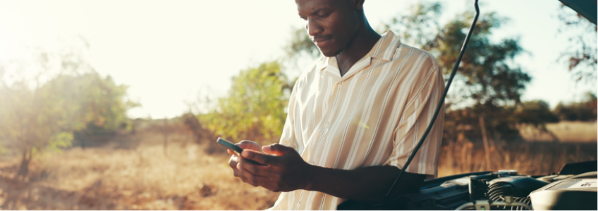 Man reviewing mobile payment options after vehicle breakdown