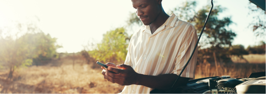 Man reviewing mobile payment options after vehicle breakdown